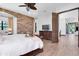 Beautiful bedroom featuring a brick accent wall and luxurious furnishings at 3100 Barbour Trl, Odessa, FL 33556