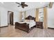Classic main bedroom featuring a ceiling fan, a large bed, and wood-look tile floors at 3100 Barbour Trl, Odessa, FL 33556
