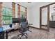 Spacious office with a large monitor, wood floors, and natural light at 3100 Barbour Trl, Odessa, FL 33556