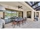 Covered outdoor dining area with seating for eight and views of the pool and backyard at 3100 Barbour Trl, Odessa, FL 33556