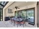 Outdoor kitchen with grill, dining area, ceiling fan and access to pool area at 3100 Barbour Trl, Odessa, FL 33556