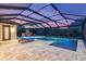 Private pool with fountains, stone fireplace, and screened enclosure offering serene outdoor living at 3100 Barbour Trl, Odessa, FL 33556