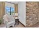 Cozy sitting area with brick wall, comfortable chair, and natural light at 3100 Barbour Trl, Odessa, FL 33556
