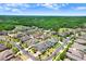 Aerial view of a well-planned community featuring beautiful homes, manicured lawns, and mature landscaping at 3243 Watermark Dr, Wesley Chapel, FL 33544
