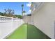 Side yard with putting green for practice and enjoyment, surrounded by privacy fence at 3243 Watermark Dr, Wesley Chapel, FL 33544