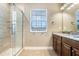 Bright bathroom featuring a glass shower, granite counters and tan color pallete at 3243 Watermark Dr, Wesley Chapel, FL 33544