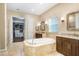 Luxurious bathroom with soaking tub, double vanities, and a walk-in closet at 3243 Watermark Dr, Wesley Chapel, FL 33544