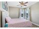 Bright bedroom with a white-painted wood bed and colorful, decorative pillows and wall decor at 3243 Watermark Dr, Wesley Chapel, FL 33544