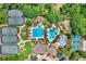 Aerial view of resort-style community pool area with tennis courts, splash pad, and clubhouse at 3243 Watermark Dr, Wesley Chapel, FL 33544