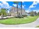 Beautiful two-story home with well-manicured landscaping and a three-car garage on a sunny day at 3243 Watermark Dr, Wesley Chapel, FL 33544