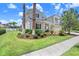 Beautifully landscaped front yard with a well-maintained lawn and mature palm trees at 3243 Watermark Dr, Wesley Chapel, FL 33544