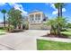 Beautiful home exterior featuring lush landscaping, mature trees, and a spacious driveway at 3243 Watermark Dr, Wesley Chapel, FL 33544