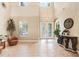 Spacious foyer with high ceilings, tiled floors, and decorative furniture creating a grand entrance at 3243 Watermark Dr, Wesley Chapel, FL 33544