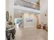 Stunning foyer featuring a staircase, an upper balcony, and stylish decor that offers a glimpse into the home's elegance at 3243 Watermark Dr, Wesley Chapel, FL 33544