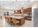Spacious kitchen featuring a large island with seating, granite countertops, and ample cabinet space at 3243 Watermark Dr, Wesley Chapel, FL 33544