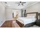 Spacious bedroom with a king-size bed and an en-suite bathroom with a soaking tub at 3243 Watermark Dr, Wesley Chapel, FL 33544
