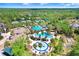 Beautiful aerial shot of community with inviting pools, tennis courts, and a well-maintained clubhouse in a green landscape at 3243 Watermark Dr, Wesley Chapel, FL 33544