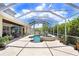 Screened-in pool and spa with water feature and ample patio space at 3243 Watermark Dr, Wesley Chapel, FL 33544