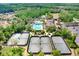 Aerial view of the tennis courts and a pool, surrounded by a lush, green landscape in a community setting at 3243 Watermark Dr, Wesley Chapel, FL 33544