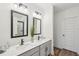 Modern bathroom with double sinks, quartz countertop, gray cabinets, black hardware, and stylish lighting at 3269 Reservoir St, North Port, FL 34288