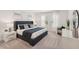 Stylish main bedroom featuring a king bed, nightstands, lamps, dresser and a relaxing chair at 3269 Reservoir St, North Port, FL 34288