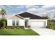Charming single-story home featuring a two-car garage, well-manicured lawn, and welcoming front entrance at 3269 Reservoir St, North Port, FL 34288