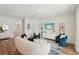 Open-concept living room with stylish decor, wood floors, and ample natural light at 3269 Reservoir St, North Port, FL 34288