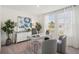 Modern home office featuring a sleek desk, chairs, and bright natural light from the window at 3269 Reservoir St, North Port, FL 34288