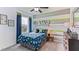 Dinosaur themed bedroom with striped walls, ceiling fan, and lots of natural light at 33110 Osprey Peak Way, San Antonio, FL 33576