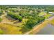 Aerial view of land near a pond, showcasing the surrounding landscape and community at 3611 W Reynolds St # 1/2, Plant City, FL 33563