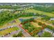 Aerial view showcasing the property's layout, surrounding greenery, and nearby water feature at 3611 W Reynolds St # 1/2, Plant City, FL 33563