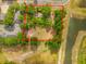 Aerial view outlining property boundaries with mature trees and nearby bodies of water at 3611 W Reynolds St # 1/2, Plant City, FL 33563