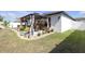 Spacious backyard with an outdoor dining area, surrounded by lush landscaping for enjoying outdoor activities and relaxation at 36568 Garden Wall Way, Zephyrhills, FL 33541