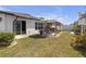 Backyard with an outdoor dining area, featuring lush landscaping, and a well-maintained lawn at 36568 Garden Wall Way, Zephyrhills, FL 33541