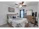 Comfortable bedroom featuring neutral walls, ceiling fan, and decorative blue and white bedding at 36568 Garden Wall Way, Zephyrhills, FL 33541