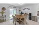 Cozy dining area with table and chairs, plus sliding doors to the outdoor area at 36568 Garden Wall Way, Zephyrhills, FL 33541