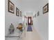 Bright hallway with tile flooring, decorative table, and front door with glass insert at 36568 Garden Wall Way, Zephyrhills, FL 33541