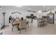 Eat-in kitchen features stainless steel appliances, island with bar seating, and white cabinetry at 36568 Garden Wall Way, Zephyrhills, FL 33541