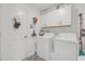 Laundry room with ample storage and modern appliances at 36568 Garden Wall Way, Zephyrhills, FL 33541