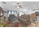 Open living room area with comfortable seating, rug, and natural light from sliding glass door at 36568 Garden Wall Way, Zephyrhills, FL 33541