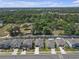Street view featuring a row of houses each with well-maintained lawns and driveways, plus tidy landscaping at 36568 Garden Wall Way, Zephyrhills, FL 33541
