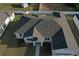 Aerial view shows the layout of the roof, landscaping, driveway, and garage of this one-story house at 37533 Teri Ct, Dade City, FL 33525
