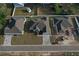 An aerial view showcases this house with its landscaping, driveway, and neighboring properties at 37533 Teri Ct, Dade City, FL 33525