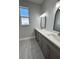 Bathroom with double sinks, tile floors, and modern mirrors at 37533 Teri Ct, Dade City, FL 33525