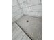 Close-up of shower floor with pebble tile design and marble-style wall tile at 37533 Teri Ct, Dade City, FL 33525