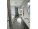 Sleek bathroom featuring double sinks, a luxurious soaking tub, and modern tile work at 37533 Teri Ct, Dade City, FL 33525