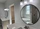 Modern bathroom featuring double sinks, large mirror, and a luxurious soaking tub at 37533 Teri Ct, Dade City, FL 33525
