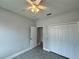 Bright bedroom with tile floors, ceiling fan, and closet at 37533 Teri Ct, Dade City, FL 33525