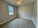 Bedroom with tile floors, a ceiling fan, and bright window at 37533 Teri Ct, Dade City, FL 33525