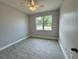 This bedroom features tile floors and a large window at 37533 Teri Ct, Dade City, FL 33525